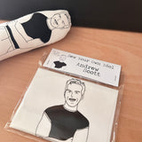 Sew Your Own Andrew Scott doll cushion craft kit. On a wooden surface.