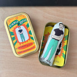 Mini fabric doll featuring Andrew Scott. The doll sits in a tin with the sticker topped lid beside.