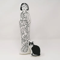 Monochrome fabric doll of psychologist Philippa Perry and her cat, Kevin standing against a  white background.