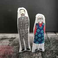Two mini fabric dolls featuring The Great British Sewing Bee hosts Patrick Grant and Esme Young.