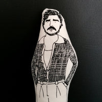 Close up of illustrated fabric doll of Pedro Pascal.