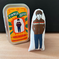 Mini illustrated fabric doll gift featuring Oasis lead guitarist, Noel  Gallagher, with a keepsake tin.