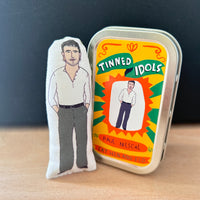 Mini fabric collectible doll and keepsake tin featuring an illustration of Irish actor Paul Mescal. On a wooden surface.