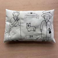  Queen Elizabeth II cushion on a wooden surface