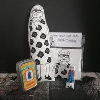 A selection of gifts featuring The Great British Sewing Bee host, Esme Young. A fabric doll, mini doll and craft kit. All set against a black background.