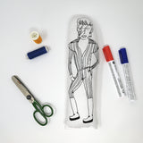 Screen printed fabric doll of David Bowie on a white background surrounded by craft supplies