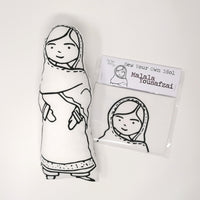 Black and white screen printed fabric doll of Malala Yousafzai next to a craft kit
