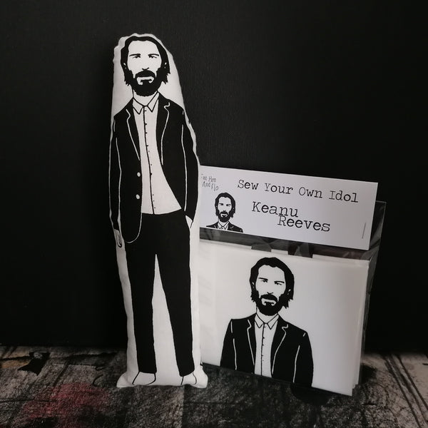  black and white screen printed fabric doll featuring an illustration of Keanu Reeves plus a craft sewing kit.