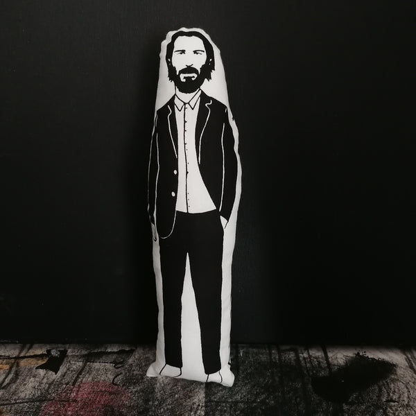 A black and white screen printed fabric doll featuring an illustration of Keanu Reeves.