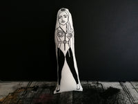A black and white screen printed doll featuring an illustration of Madonna.