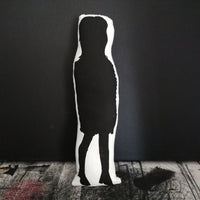 Reverse of fabric doll featuring a silhouette design of Noel Fielding. 