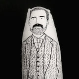 Close up of a black and white illustrated doll of Patrick Grant.