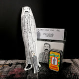 A selection of gifts featuring  Patrick Grant including a black and white fabric doll, a mini keepsake doll and tin and a craft kit.
