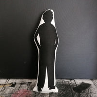 Reverse of black and white fabric doll featuring a silhouette of Pedro Pascal.