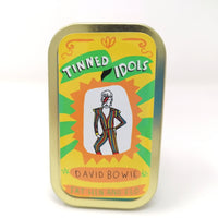 Mini fabric doll of David Bowie in a tin.