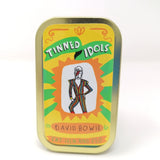 Mini fabric doll of David Bowie in a tin.