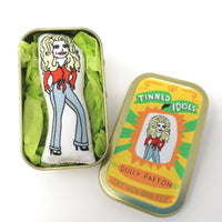 Mini fabric doll of dolly Parton in a tin.
