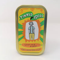 Mini fabric doll of Grayson Perry in a tin