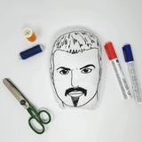 George Michael black and white cushion surrounded by pens, thread and scissors