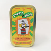 Tin containing a min doll of Joni Mitchell