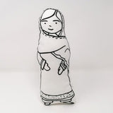 Screen printed monochrome fabric doll of Malala Yousafzai standing against a white backdrop.